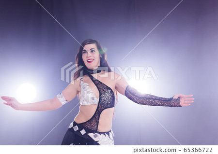 Spirituality dance. Beautiful sexy woman with luxury glossy eastern make-up dancing tribal fusion. Belly dance. 65366722