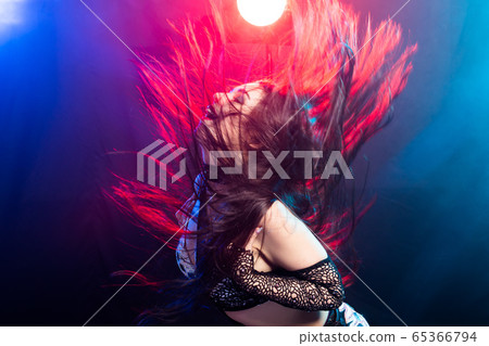 Young woman dancing in Tribal Fusion style. Belly dance on the stage. Young woman dancing in Tribal Fusion style. Belly dance on the stage. 65366794