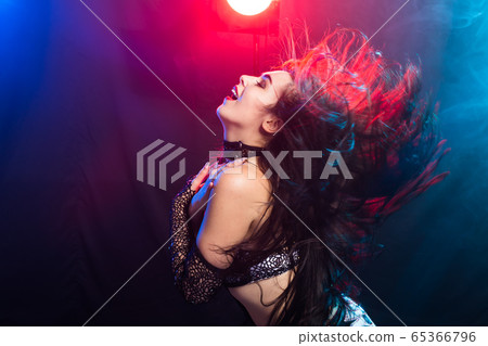 Young woman belly dancer in exotic dress with gold, dancing tribal fusion dance in studio. 65366796