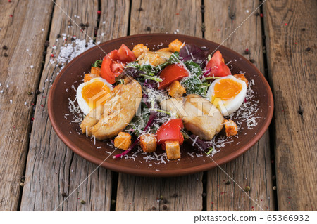 Fresh vegetable salad served with fried meat Fresh vegetable salad served with fried meat 65366932