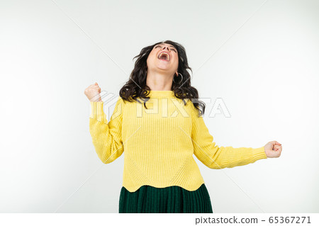 charming stylish girl in a yellow blouse and a green skirt dancing energetically on an isolated charming stylish girl in a yellow blouse and a green skirt dancing energetically on an isolated 65367271