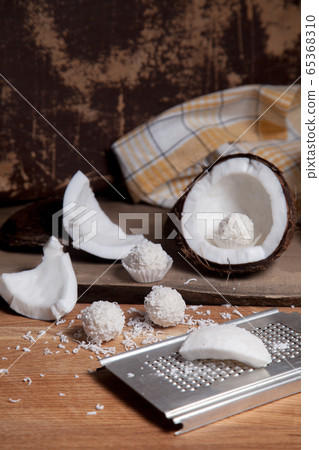 Close up of coconut with white pulp, grater with Close up of coconut with white pulp, grater with 65368310