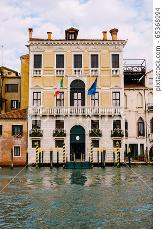 Old houses on Grand Canal, Venice, Italy. Vintage hotels and residential buildings in the Venice center. Historical architecture of Venice on water in summer. Venetian street with ancient facades. Old houses on Grand Canal, Venice, Italy. Vintage hotels and residential buildings in the Venice center. Historical architecture of Venice on water in summer. Venetian street with ancient facades. 65368994