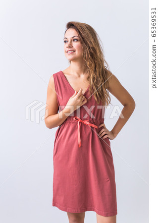 Fashion, summer and vacation concept - beautiful female model in brown dress on white background. Fashion, summer and vacation concept - beautiful female model in brown dress on white background. 65369531
