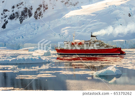 Red cruise steamboat drifting among the icebergs Red cruise steamboat drifting among the icebergs 65370262
