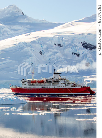Red cruise steamboat drifting among the icebergs Red cruise steamboat drifting among the icebergs 65370263