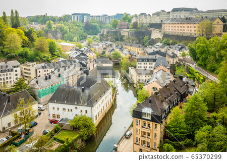 Alzette river bend with old houses along Alzette river bend with old houses along 65370299