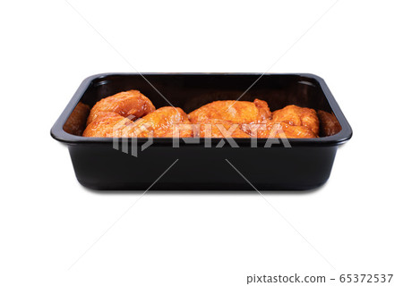 Vacuum packaging.Fresh, raw chicken thigh in the package.Chicken legs in red marinade in plastic packaging for supermarkets.Isolated Vacuum packaging.Fresh, raw chicken thigh in the package.Chicken legs in red marinade in plastic packaging for supermarkets.Isolated 65372537
