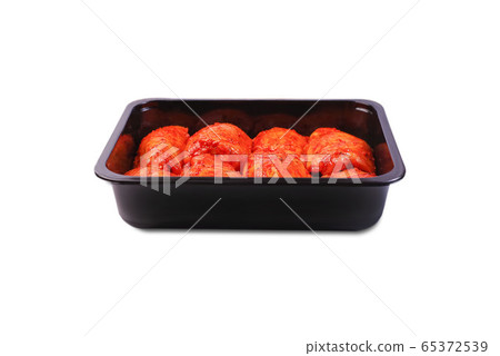 Chicken legs in red marinade in plastic packaging for supermarkets.Vacuum packaging.Fresh, raw chicken thigh in the package.Isolated Chicken legs in red marinade in plastic packaging for supermarkets.Vacuum packaging.Fresh, raw chicken thigh in the package.Isolated 65372539