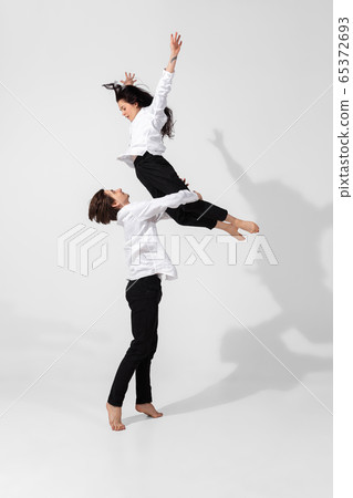 Young and graceful ballet dancers in minimal black style isolated on white studio background Young and graceful ballet dancers in minimal black style isolated on white studio background 65372693