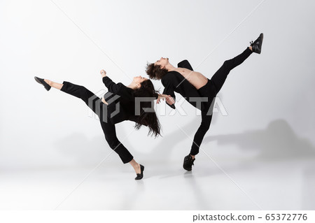 Young and graceful ballet dancers in minimal black style isolated on white studio background Young and graceful ballet dancers in minimal black style isolated on white studio background 65372776
