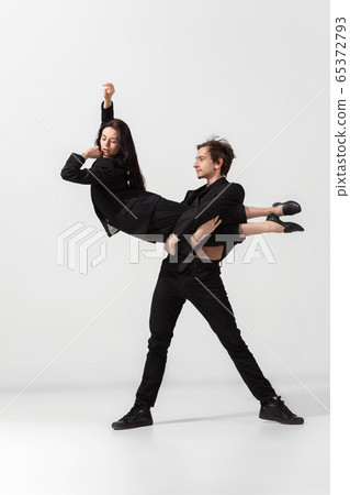 Young and graceful ballet dancers in minimal black style isolated on white studio background 65372793