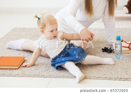Cute baby girl playing indoors. Childhood, infant and children concept. Cute baby girl playing indoors. Childhood, infant and children concept. 65372920