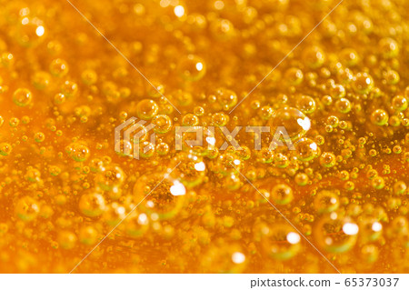 Liquid yellow paste for sugaring close-up. Depilation and hair removal concept. Macro photo. 65373037