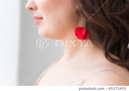 Elegant woman with earrings, close up portrait. Accessories, jewelry and bijouterie concept. Elegant woman with earrings, close up portrait. Accessories, jewelry and bijouterie concept. 65373455