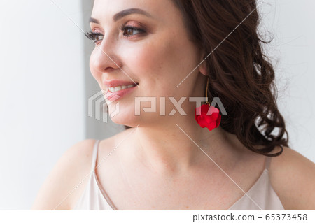 Close-up portrait of beautiful young woman with elegant hairstyle and luxurious jewelry and bijouterie. Close-up portrait of beautiful young woman with elegant hairstyle and luxurious jewelry and bijouterie. 65373458