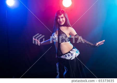 Spirituality dance. Beautiful sexy woman with luxury glossy eastern make-up dancing tribal fusion. Belly dance. 65373635