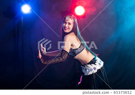 Spirituality dance. Beautiful sexy woman with luxury glossy eastern make-up dancing tribal fusion. Belly dance. 65373652