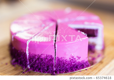 Pink and violet birthday cake without one piece. Dessert, holidays and delicious concept. 65374618