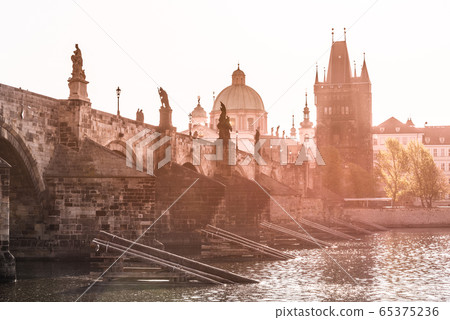 Morning on Charles Bridge, Czech: Karluv most. Hazy sunrise daybreak. Praha, Czech Republic Morning on Charles Bridge, Czech: Karluv most. Hazy sunrise daybreak. Praha, Czech Republic 65375236