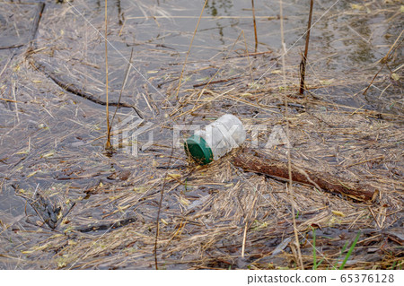 Plastic and bottle in river, garbage pollution Plastic and bottle in river, garbage pollution 65376128