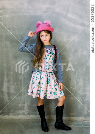 Stylish girl with pretty face on grey background. Hairdresser, skincare, casual style, denim. Fashion model and beauty look. Little girl with long hair. Beauty and kid fashion with healthy hair. Stylish girl with pretty face on grey background. Hairdresser, skincare, casual style, denim. Fashion model and beauty look. Little girl with long hair. Beauty and kid fashion with healthy hair. 65376828