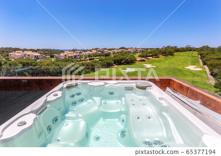 Modern luxurious pool, jacuzzi with hydromassage, with beautiful views and greenery, for tourists, in the hotel. Modern luxurious pool, jacuzzi with hydromassage, with beautiful views and greenery, for tourists, in the hotel. 65377194