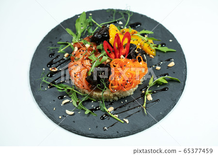 Hawaiian salmon fish poke bowl with rice, radish,cucumber, tomato, sesame seeds and seaweeds. Buddha bowl. Diet food Hawaiian salmon fish poke bowl with rice, radish,cucumber, tomato, sesame seeds and seaweeds. Buddha bowl. Diet food 65377459