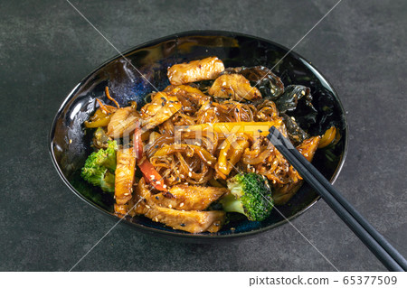 Asian noodles with meat on plate 65377509