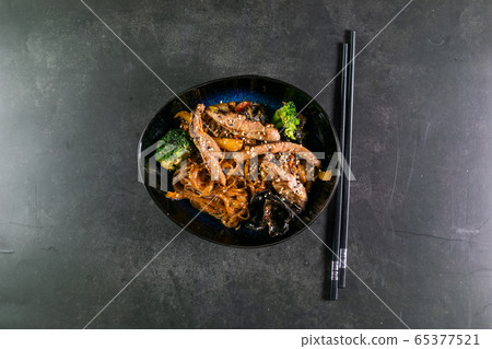 Asian noodles with meat on plate Asian noodles with meat on plate 65377521