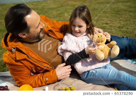 Cute little girl spending time with daddy outdoors Cute little girl spending time with daddy outdoors 65378290