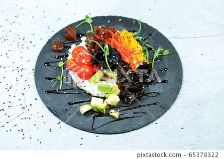 Poke bowl with raw salmon, rice, pineapple and vegetables Poke bowl with raw salmon, rice, pineapple and vegetables 65378322