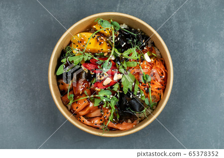 Hawaiian salmon fish poke bowl with rice, radish,cucumber, tomato, sesame seeds and seaweeds. Buddha bowl. Diet food Hawaiian salmon fish poke bowl with rice, radish,cucumber, tomato, sesame seeds and seaweeds. Buddha bowl. Diet food 65378352