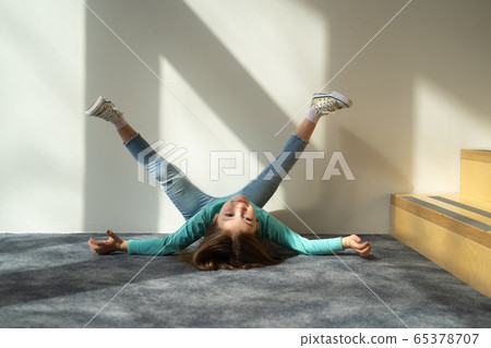 Cute kid lying on the floor and raising legs Cute kid lying on the floor and raising legs 65378707