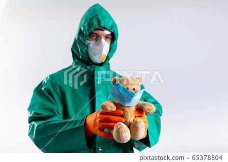Man with teddy bear Coronavirus pandemic concept stock photo 65378804