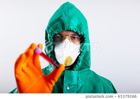 Serious medical worker looking at the blood sample stock photo Serious medical worker looking at the blood sample stock photo 65379166