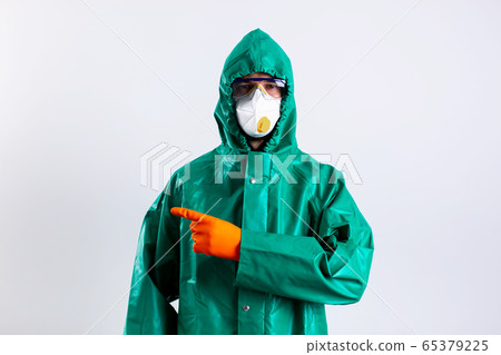 Man in disinfectant suit showing the direction stock photo Man in disinfectant suit showing the direction stock photo 65379225