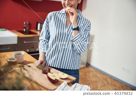 Hungry Caucasian woman having snack at home Hungry Caucasian woman having snack at home 65379832