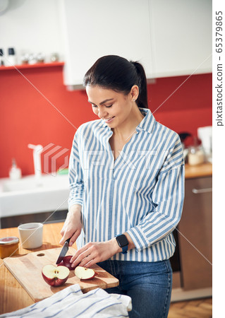 Pretty Caucasian lady is going to eat juicy fruit at home Pretty Caucasian lady is going to eat juicy fruit at home 65379865