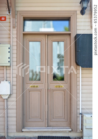 Old beige wooden entrance door of house 65379952