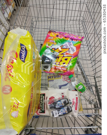 Groceries that have been picked up are placed in the cart before payment is made at the payment counter. Shopping carts make it easy for customers to shop. 65380438