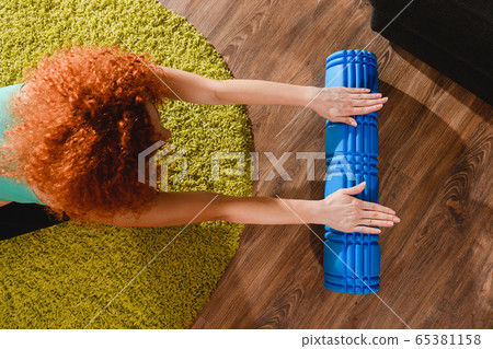 Up view of woman with yoga roller Up view of woman with yoga roller 65381158