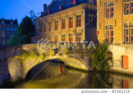 Ancient bridge at Dijver Canal in Bruges at night. Ancient bridge at Dijver Canal in Bruges at night. 65381218