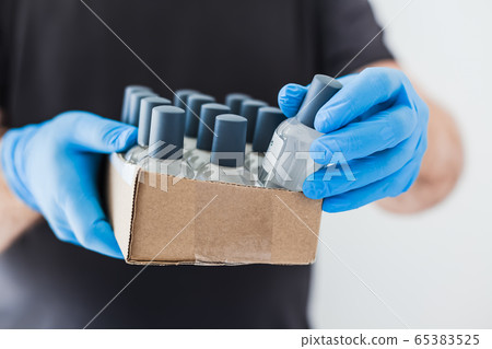 Hand sanitizer hygiene alcohol gel bottle in hands Hand sanitizer hygiene alcohol gel bottle in hands 65383525