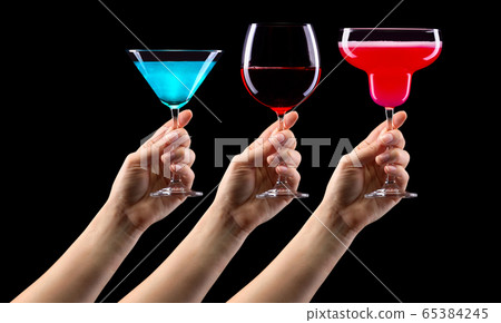 Set of hands holding cocktails isolated on black background 65384245