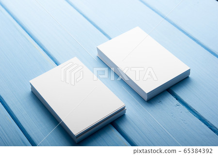 Business card blank on blue wooden background. Corporate Stationery, Branding Mock-up. Creative designer desk. Flat lay. Copy space for text 65384392