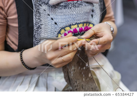 Knitting, sewing, or making nails 65384427