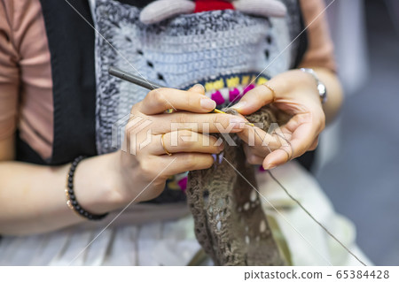 Knitting, sewing, or making nails 65384428