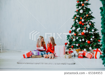 Christmas holiday two girl with presents new year Christmas tree on a grey background gifts 65384953