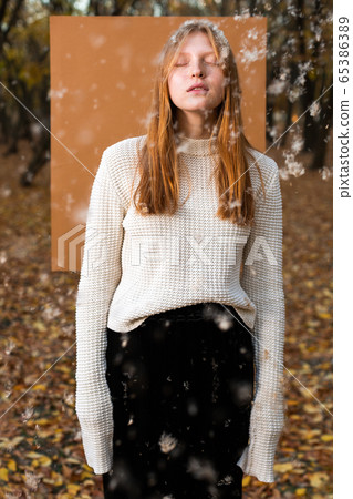 Female model in white jumper with flying fuzz Female model in white jumper with flying fuzz 65386389